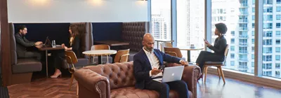 Business professionals use Servcorp’s breakout spaces for solo tasks, calls, and laptop work in comfort.